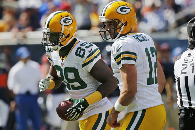 Green Bay Packers quarterback Aaron Rodgers (12) celebrates a touchdown with wide receiver James Jones (89) during the first half an NFL football game against the Chicago Bears, Sunday, Sept. 13, 2015, in Chicago. (AP Photo/Charles Rex Arbogast)