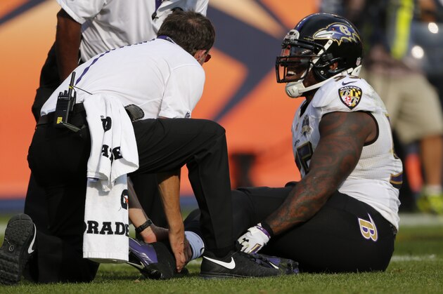 Baltimore Ravens outside linebacker Terrell Suggs is treated on the field during the second half of an NFL football game against the Denver Broncos Sunday, Sept. 13, 2015, in Denver. (AP Photo/Jack Dempsey)