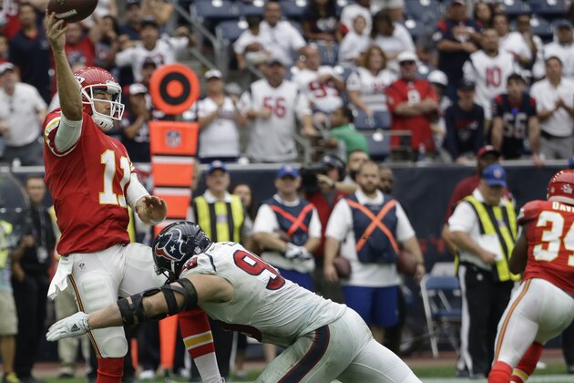 Kansas City Chiefs quarterback Alex Smith (11) is hit by Houston Texans defensive end J.J. Watt (99) as he throws during the second half of an NFL football game Sunday, Sept. 13, 2015, in Houston. (AP Photo/David J. Phillip)