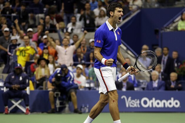 Novak Djokovic, of Serbia, reacts after breaking Roger Federer's serve to win a game in the fourth set during the men's championship match of the U.S. Open tennis tournament, Sunday, Sept. 13, 2015, in New York. (AP Photo/David Goldman)