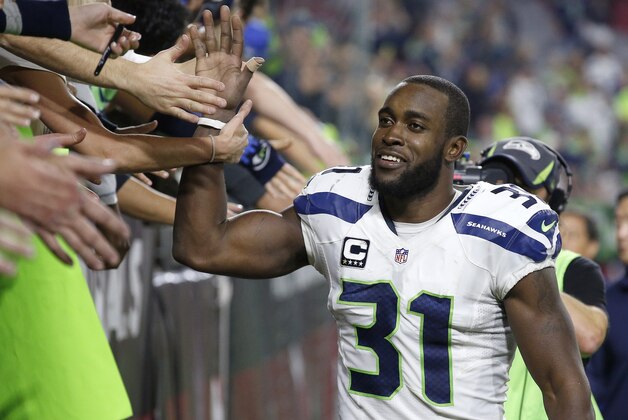 Seattle Seahawks' Kam Chancellor (31) celebrates with Seahawks fans after an NFL football game against the Arizona Cardinals Sunday, Dec. 21, 2014, in Glendale, Ariz.  The Seahawks defeated the Cardinals 35-6. (AP Photo/Ross D. Franklin)