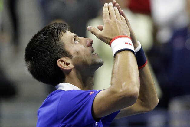 Novak Djokovic, of Serbia, celebrates after beating Roger Federer, of Switzerland, in the men's championship match of the U.S. Open tennis tournament, Sunday, Sept. 13, 2015, in New York. (AP Photo/Bill Kostroun)