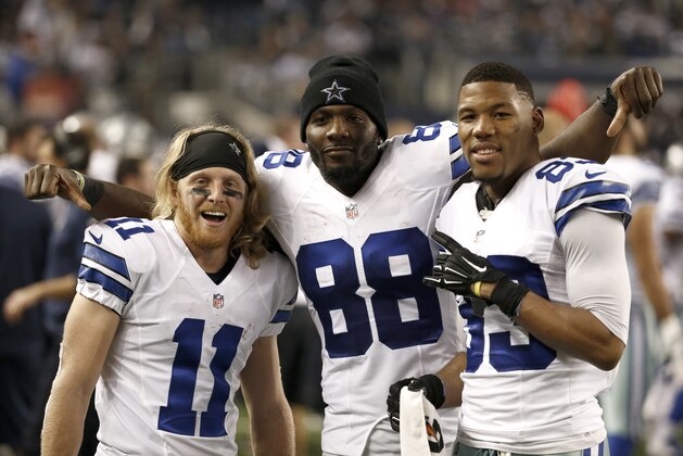 Dallas Cowboys' Cole Beasley (11), Dez Bryant (88) and Terrance Williams, right, poses for photographers on the sideline during the second  half of an NFL football game against the Indianapolis Colts, Sunday, Dec. 21, 2014, in Arlington, Texas. (AP Photo/Brandon Wade)