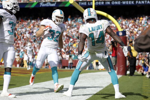Miami Dolphins wide receiver Jarvis Landry (14) celebrates his touchdown with free safety Michael Thomas (31) and defensive back Jordan Kovacs (32) during the second half of an NFL football game against the Washington Redskins, Sunday, Sept. 13, 2015, in Landover, Md. (AP Photo/Patrick Semansky)