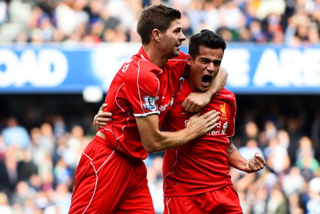 LONDON, ENGLAND - OCTOBER 19:  Philippe Coutinho of Liverpool celebrates with team-mate Steven Gerrard after scoring his team's second goal during the Barclays Premier League match between Queens Park Rangers and Liverpool at Loftus Road on October 19, 2014 in London, England.  (Photo by Paul Gilham/Getty Images)