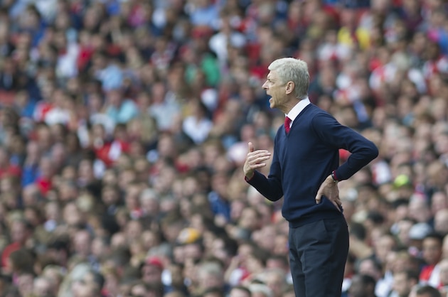 Arsenal's manager Arsene Wenger shouts instructions to his team during their English Premier League soccer match between Arsenal and Stoke City, at Emirates Stadium, in London, Saturday, Sept. 12, 2015. (AP Photo/Bogdan Maran)
