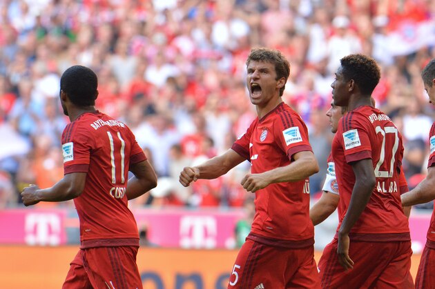 Bayern's Thomas Mueller, center, celebrates after scoring during the German Bundesliga soccer match between FC Bayern Munich and FC Augsburg in the Allianz Arena in Munich, Germany, on Saturday, Sept. 12, 2015. (AP Photo/Kerstin Joensson)