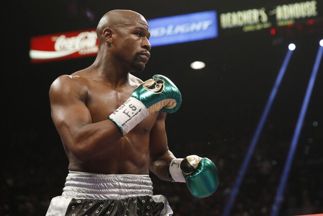 Floyd Mayweather Jr. fights Andre Berto during their welterweight title bout Saturday, Sept. 12, 2015, in Las Vegas. (AP Photo/Steve Marcus)
