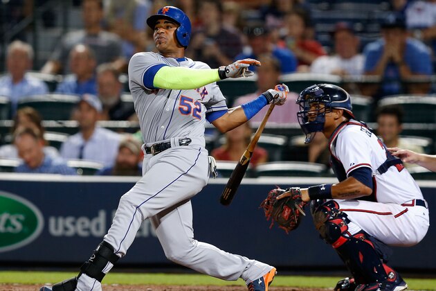 ATLANTA, GA - SEPTEMBER 11:  Centerfielder Yoenis Cespedes #52 of the New York Mets hits a 2-run home run in the eighth inning while catcher Christian Bethancourt #27 of the Atlanta Braves looks on during the game at Turner Field on September 11, 2015 in Atlanta, Georgia.  (Photo by Mike Zarrilli/Getty Images)