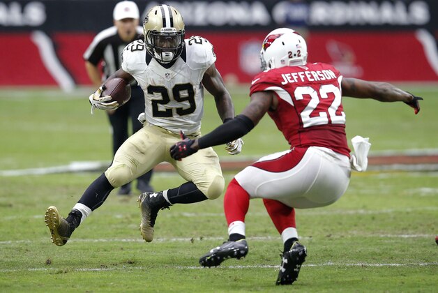 New Orleans Saints running back Khiry Robinson (29) gains yards as Arizona Cardinals strong safety Tony Jefferson (22) defends during the first half of an NFL football game, Sunday, Sept. 13, 2015, in Glendale, Ariz. (AP Photo/Rick Scuteri)