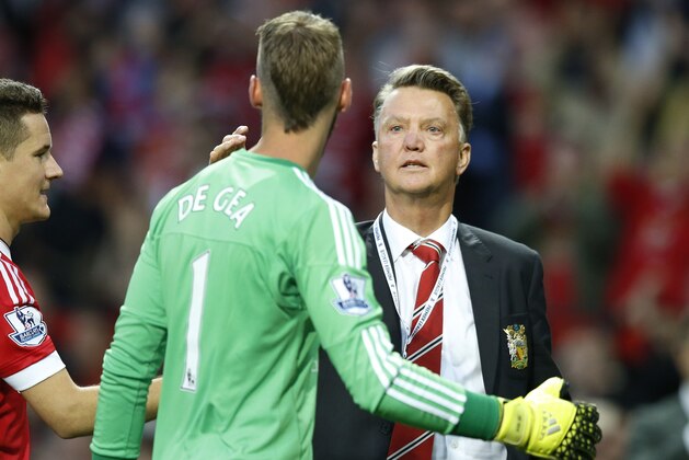 Manchester United's manager Louis van Gaal greets  goalkeeper David De Gea after the English Premier League soccer match between Manchester United and Liverpool at Old Trafford Stadium, Manchester, England, Saturday, Sept. 12, 2015.  United won the match 3-1. (AP Photo/Jon Super)