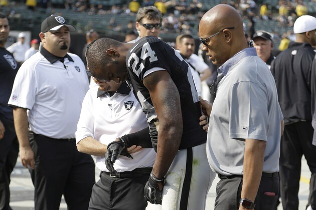 Oakland Raiders cornerback Charles Woodson (24) is helped to the sideline after being injured during the second half of an NFL football game against the Cincinnati Bengals in Oakland, Calif., Sunday, Sept. 13, 2015. The Bengals won 33-13. (AP Photo/Ben Margot)