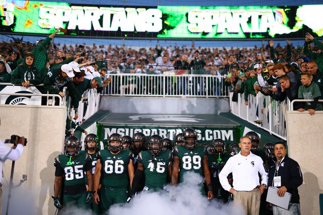 EAST LANSING, MI - SEPTEMBER 12:  Head coach Mark Dantonio of the Michigan State Spartan leads his team on the field prior to the start of the game against the Oregon Ducks at Spartan Stadium on September 12, 2015 in East Lansing, Michigan. (Photo by Rey Del Rio/Getty Images)