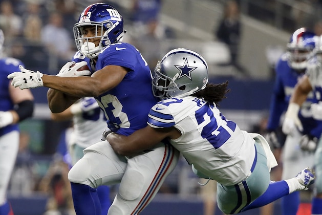 New York Giants running back Rashad Jennings (23) is taken down by Dallas Cowboys free safety J.J. Wilcox (27) during the second half of an NFL football game Sunday, Sept. 13, 2015, in Arlington, Texas. (AP Photo/Tony Gutierrez)