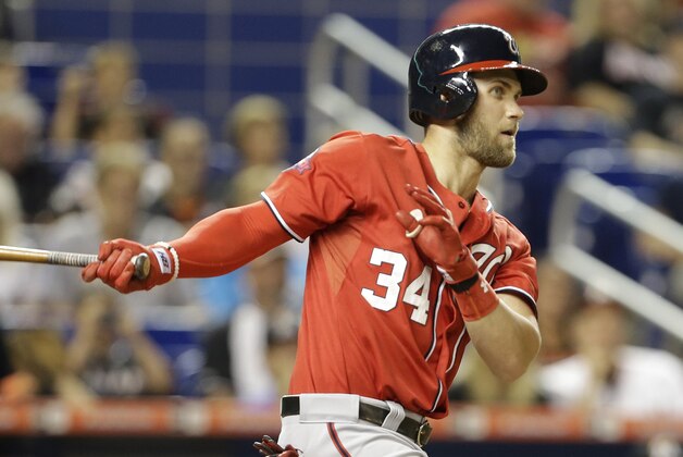 Washington Nationals' Bryce Harper follows through on a single in the fourth inning of a baseball game against the Miami Marlins, Saturday, Sept. 12, 2015, in Miami. (AP Photo/Lynne Sladky)