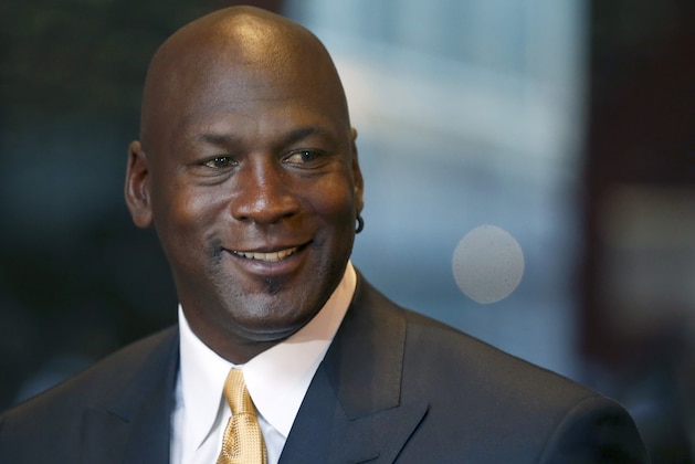 Michael Jordan smiles at reporters after a jury ordered a defunct grocery store chain to pay him $8.9 million for using his name without permission. Friday, Aug. 21, 2015, in Chicago. Jurors had to calculate how much the now-defunct grocery chain Dominick's Finer Foods should pay Jordan for invoking his name in an ad without permission. They sent one note to the judge, saying: