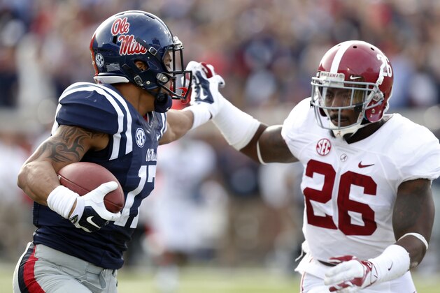 Mississippi tight end Evan Engram (17) fights off a tackle attempt by Alabama defensive back Landon Collins (26) after a long pass reception during the second half of an NCAA college football game in Oxford, Miss., Saturday, Oct. 4, 2014. No. 11 Mississippi defeated No. 3 Alabama 23-17. (AP Photo/Rogelio V. Solis)