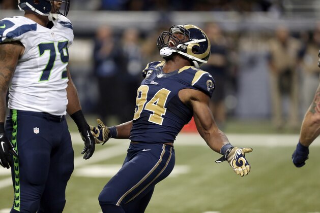 St. Louis Rams defensive end Robert Quinn celebrates after sacking Seattle Seahawks quarterback Russell Wilson during the third quarter of an NFL football game Sunday, Sept. 13, 2015, in St. Louis. (AP Photo/Tom Gannam)