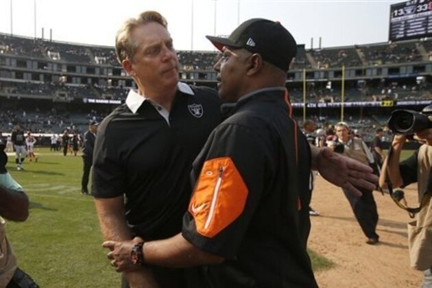 Oakland Raiders head coach Jack Del Rio, left, talks with Cincinnati Bengals head coach Marvin Lewis after an NFL football game in Oakland, Calif., Sunday, Sept. 13, 2015. The Bengals won 33-13. (AP Photo/Tony Avelar)