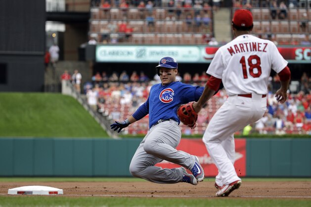 Chicago Cubs' Anthony Rizzo, left, is safe at third as St. Louis Cardinals starting pitcher Carlos Martinez covers during the first inning of a baseball game on Wednesday, Sept. 9, 2015, in St. Louis. Rizzo hit a RBI double and was able to make it to third on the throw. (AP Photo/Jeff Roberson)