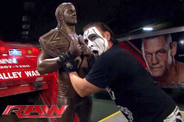 Sting trashes a statue of Seth Rollins.