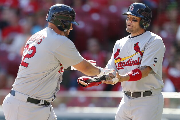 St. Louis Cardinals Matt Adams (32) is congratulated by Yadier Molina (4) after hitting a two-run homer off Cincinnati Reds starting pitcher Josh Smith (64), during the eighth inning of a baseball game, Sunday, Sept. 13, 2015, in Cincinnati. (AP Photo/Gary Landers)