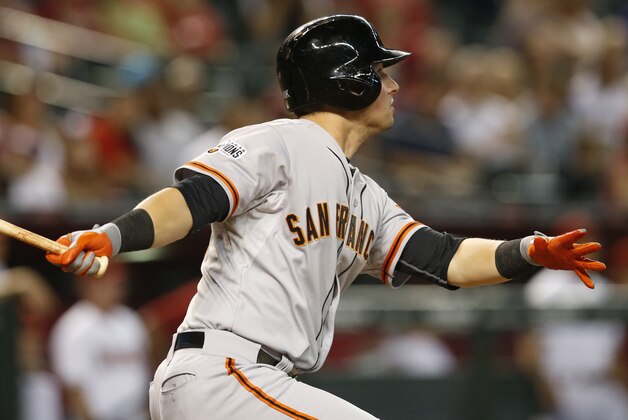 San Francisco Giants second baseman Joe Panik (12) hits a double n the eighth inning during a baseball game against the Arizona Diamondbacks, Monday, Sept. 7, 2015, in Phoenix. (AP Photo/Rick Scuteri)
