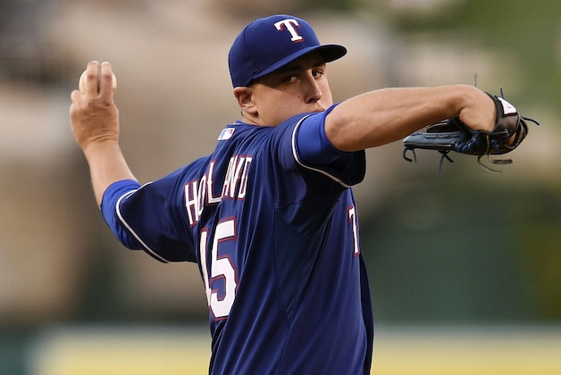 Sep 5, 2015; Anaheim, CA, USA; Texas Rangers starting pitcher Derek Holland (45) pitches against the Los Angeles Angels during the first inning at Angel Stadium of Anaheim. Mandatory Credit: Kelvin Kuo-USA TODAY Sports