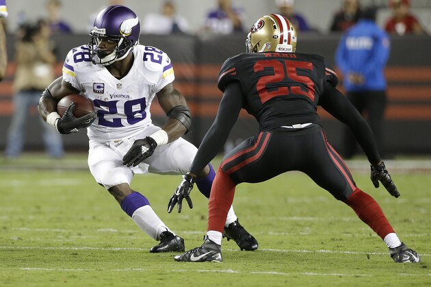 Minnesota Vikings running back Adrian Peterson (28) runs against San Francisco 49ers strong safety Jimmie Ward (25) during the second half of an NFL football game in Santa Clara, Calif., Monday, Sept. 14, 2015. (AP Photo/Marcio Jose Sanchez)