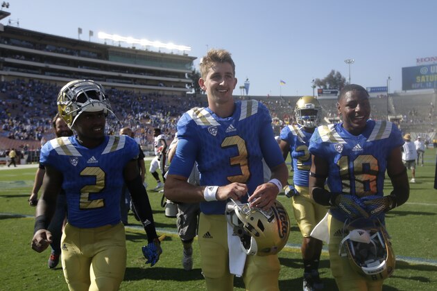 UCLA quarterback Josh Rosen, center, walks off the field after an NCAA college football game against Virginia at Rose Bowl, Saturday, Sept. 5, 2015, in Pasadena, Calif. UCLA won 34-16. (AP Photo/Jae C. Hong)