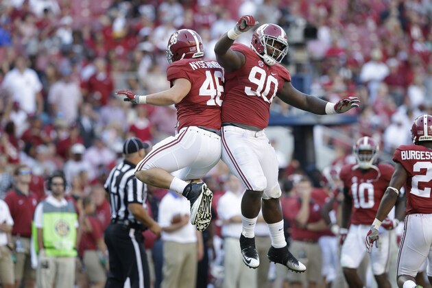 Alabama Crimson defensive lineman Jarran Reed (90) and Alabama Crimson tight end Michael Nysewander (46) celebrate after a tackle during the second half of an NCAA college football game, Saturday, Sept. 12, 2015, in Tuscaloosa, Ala. Alabama won 37-10. (AP Photo/Brynn Anderson)