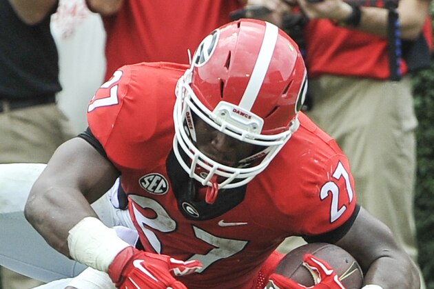 Georgia running back Nick Chubb (27) dives for a touchdown over Louisiana Monroe safety Mitch Lane during the first half of an NCAA college football game, Saturday, Sept. 5, 2015, in Athens, Ga. (AP Photo/John Amis)