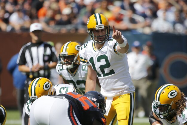 Green Bay Packers quarterback Aaron Rodgers (12) calls a play during the first half an NFL football game against the Chicago Bears,  Sunday, Sept. 13, 2015, in Chicago. (AP Photo/Charles Rex Arbogast)
