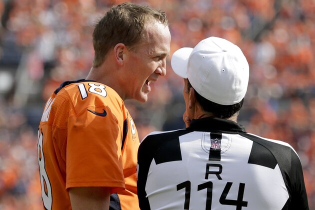 Denver Broncos quarterback Peyton Manning, left, talks with referee Gene Steratore (114) during the first half of an NFL football game against the Baltimore Ravens Sunday, Sept. 13, 2015, in Denver. (AP Photo/Jack Dempsey)