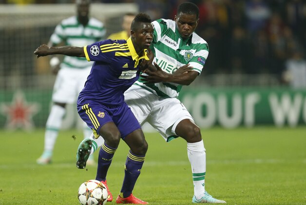 Maribor's Sintayehu Sallalich, left, fights for the ball with Sporting's William Carvalho during the Champions League Group G soccer match between Maribor and Sporting, in Maribor, Slovenia, Wednesday, Sept. 17, 2014. (AP Photo/Darko Bandic)