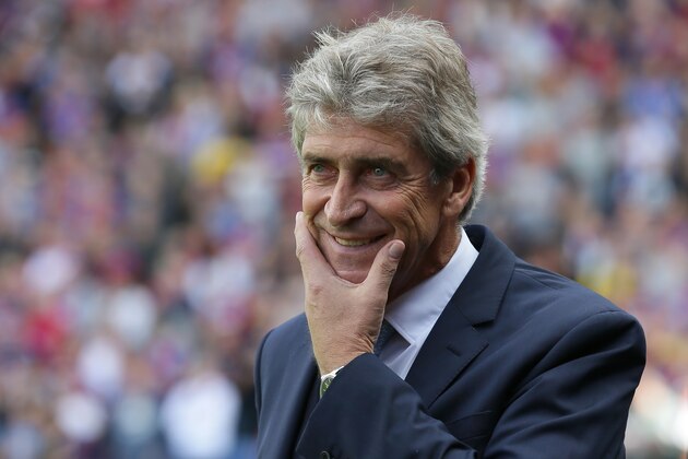 Manchester City manager Manuel Pellegrini smiles as he walks onto the pitch before the English Premier League soccer match between Crystal Palace and Manchester City at Selhurst Park, London, Saturday, Sept. 12, 2015. (AP Photo/Tim Ireland)