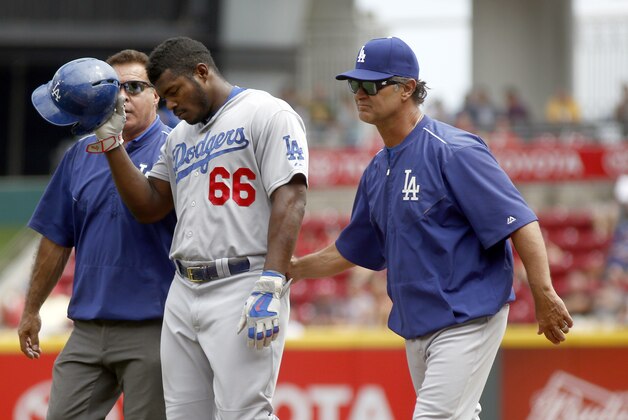 Aug 27, 2015; Cincinnati, OH, USA; Los Angeles Dodgers right fielder Yasiel Puig (66) leaves the game with manager Don Mattingly (right) in the ninth inning against the Cincinnati Reds at Great American Ball Park. Mandatory Credit: David Kohl-USA TODAY Sports