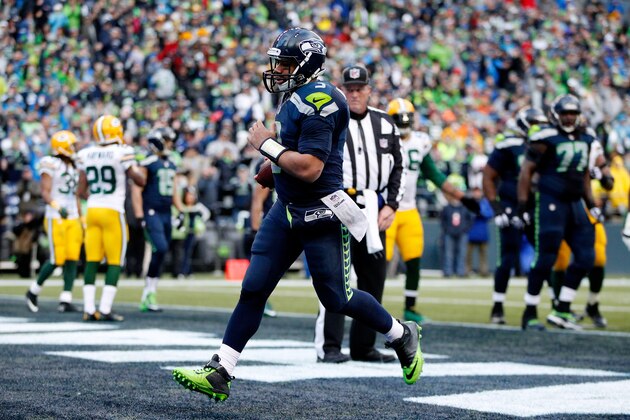 SEATTLE, WA - JANUARY 18:  Russell Wilson #3 of the Seattle Seahawks rushes for a touchdown against the Green Bay Packers during the 2015 NFC Championship game at CenturyLink Field on January 18, 2015 in Seattle, Washington.  (Photo by Otto Greule Jr/Getty Images)
