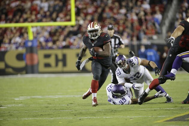 San Francisco 49ers running back Carlos Hyde (28) runs past Minnesota Vikings outside linebacker Chad Greenway (52) and defensive end Danielle Hunter (99) during the second half of an NFL football game in Santa Clara, Calif., Monday, Sept. 14, 2015. The 49ers won 20-3. (AP Photo/Marcio Jose Sanchez)