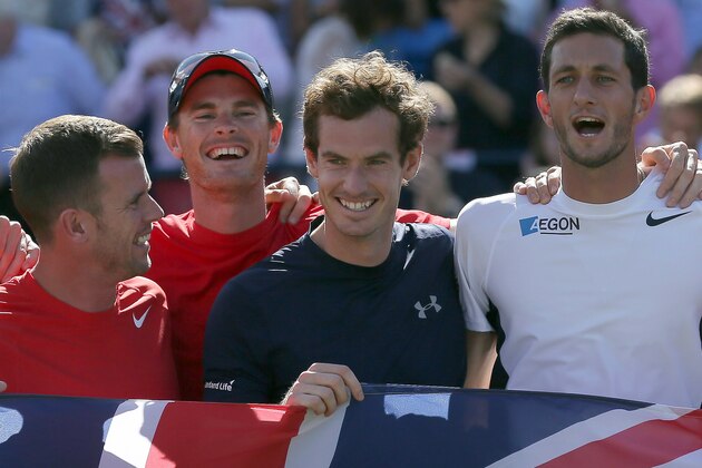 Britain's Andy Murray, centre, celebrates with his teammates after beating France's Gilles Simon, taking Britain to the semifinal stage, winning the quarterfinal tennis matches of the Davis Cup at the Queen's Club in London, Sunday July 19, 2015. (AP Photo/Tim Ireland)