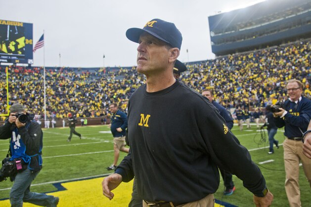 Michigan head coach Jim Harbaugh walks off the field after an NCAA college football game against Oregon State in Ann Arbor, Mich., Saturday, Sept. 12, 2015. Michigan won 35-7. (AP Photo/Tony Ding)