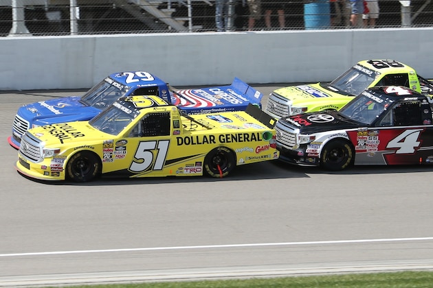 Kyle Busch (51), Ryan Blaney (29), Erik Jones (4) and Matt Crafton (88) race during the NASCAR Truck series Careers for Veterans 200 race at Michigan International Speedway, Saturday, Aug. 15, 2015, in Brooklyn, Mich. (AP Photo/Bob Brodbeck)