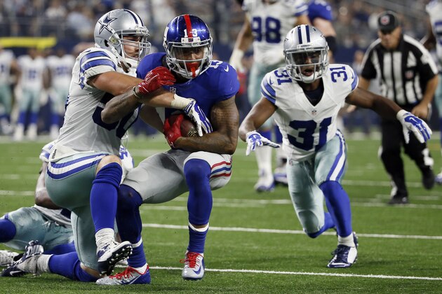 Dallas Cowboys middle linebacker Sean Lee (50) tackles New York Giants wide receiver Odell Beckham (13) as cornerback Byron Jones (31) moves in during the second half of an NFL football game Sunday, Sept. 13, 2015, in Arlington, Texas. (AP Photo/Tony Gutierrez)