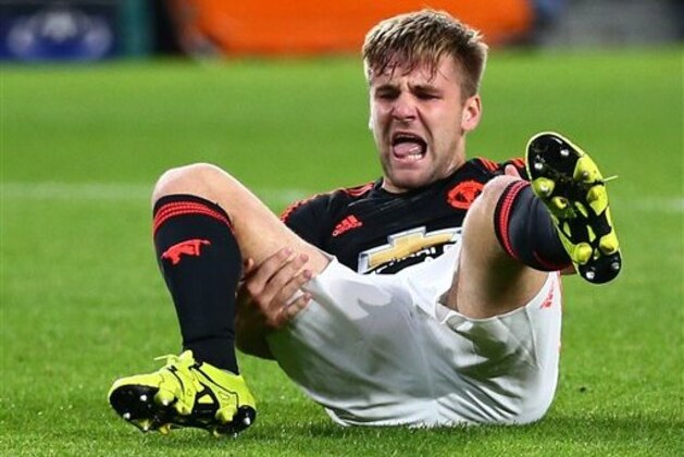 Manchester United’s Luke Shaw grimaces after being injured during the Champions League Group B soccer match between PSV and Manchester United at Philips stadium in Eindhoven, Netherlands, Tuesday, Sept. 15, 2015. (AP Photo/Peter Dejong)