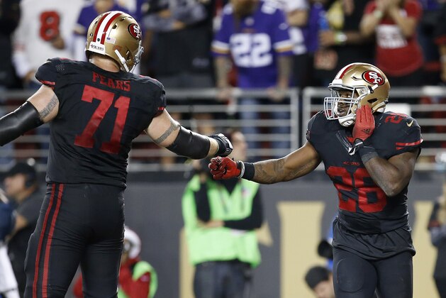 San Francisco 49ers running back Carlos Hyde (28) celebrates with tackle Erik Pears (71) after running for a 10-yard touchdown during the first half of an NFL football game against the Minnesota Vikings in Santa Clara, Calif., Monday, Sept. 14, 2015. (AP Photo/Tony Avelar)