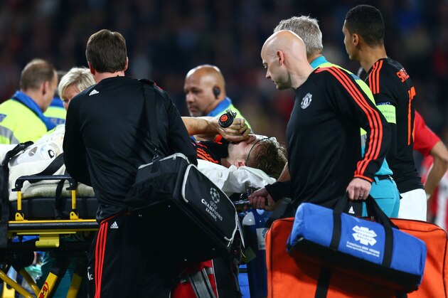 Manchester United’s Luke Shaw is taken off the pitch by medical staff after being injured during the Champions League Group B soccer match between PSV and Manchester United at Philips stadium in Eindhoven, Netherlands, Tuesday, Sept. 15, 2015. (AP Photo/Peter Dejong)