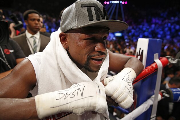 Floyd Mayweather Jr. motions to the crowd after his welterweight title boxing bout with Andre Berto Saturday, Sept. 12, 2015, in Las Vegas. (AP Photo/John Locher)