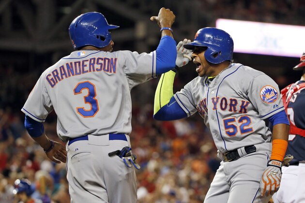 New York Mets' Curtis Granderson celebrates scoring with Yoenis Cespedes (52) on Cespedes' two-run home run during the eighth inning of a baseball game against the Washington Nationals at Nationals Park, Wednesday, Sept. 9, 2015, in Washington. The Mets won 5-3. (AP Photo/Alex Brandon)