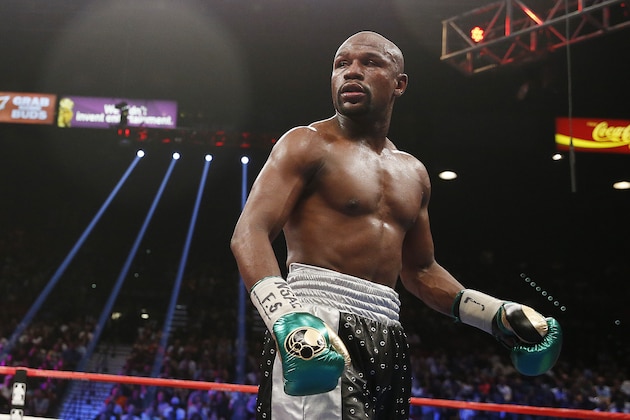 Floyd Mayweather Jr. looks at Andre Berto during their welterweight title boxing bout Saturday, Sept. 12, 2015, in Las Vegas. (AP Photo/John Locher)