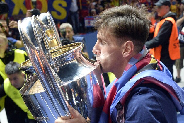 Barcelona's Lionel Messi kisses the trophy after his team won 3-1 the Champions League final soccer match between Juventus Turin and FC Barcelona at the Olympic stadium in Berlin Saturday, June 6, 2015. (AP Photo/Martin Meissner)